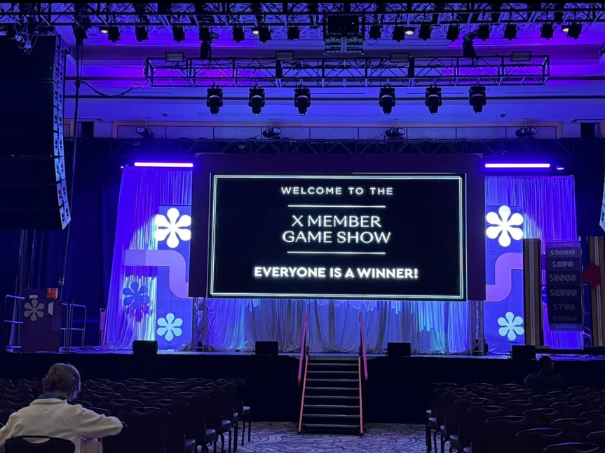 Game show stage with a large video screen and purple lighting