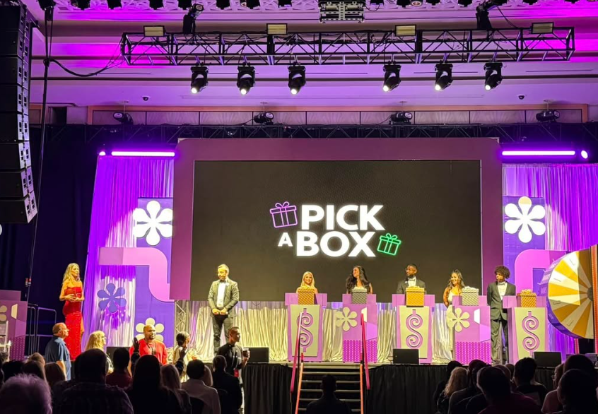 Live game show with contestants beneath stage lighting